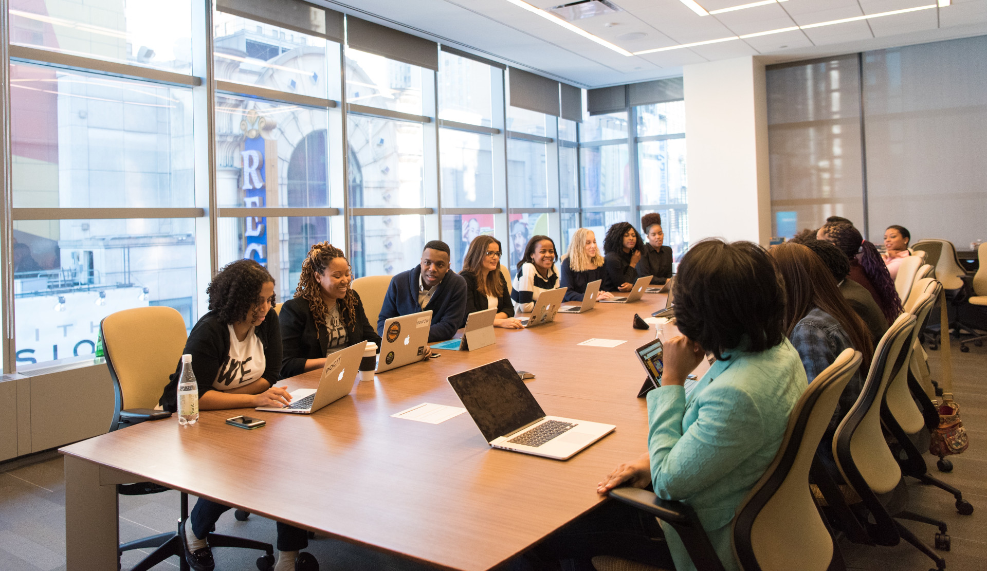 Decorative image of people in conference room discussing operations.
